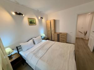 a bedroom with a large white bed with two pillows at Piața Ovidiu 14 Loft in Constanţa