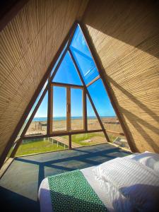 a bedroom with a large window in a tent at Chader Bari Beach Resort, Cox's Bazar in Cox's Bazar +4 photos