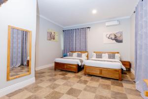 a bedroom with two beds and a mirror at Sunset Villa in Usa +140 photos