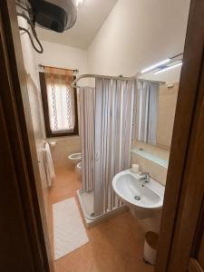 a bathroom with a shower and a sink and a toilet at Casa Rosada Alghero in Alghero +14 photos