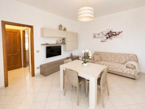 a living room with a table and a couch at Casa Rosada Alghero in Alghero