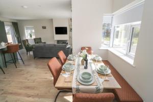 a dining table and chairs in a living room at Red House in Galway