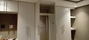 a bathroom with white cabinets and a shower at Mkhuzewamanzi Accommodation in Mkuze