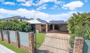 a house with solar panels on the roof at Spacious home with pool in Kippa-Ring in Newport