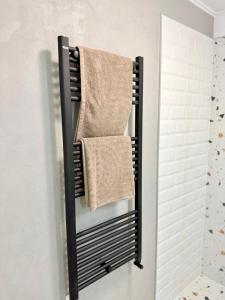a towel rack with towels hanging on a wall at Piața Ovidiu 14 Loft in Constanţa