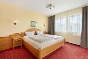 a bedroom with a large bed with a wooden frame at Superior Apt mit Seeblick K2 002 in Spalt