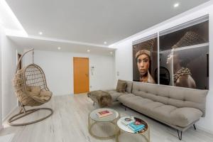 a living room with a couch and a chair at Spacious 3-bedroom condo near Lisbon Airport in Lisbon