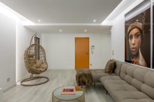 a living room with a couch and a chair at Spacious 3-bedroom condo near Lisbon Airport in Lisbon