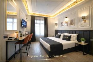 a hotel room with a bed and a desk at Angel's Home Hotel - Angel Group Hotels in Istanbul
