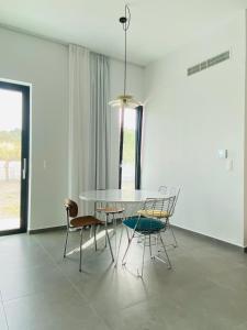 a dining room with a table and chairs at Lefko Apartments in Tavronitis