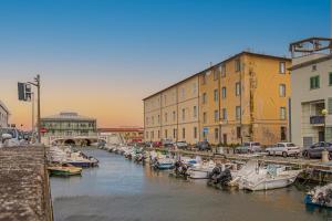 a group of boats are docked in a canal with buildings at I Bimbi - Suite Apartment in Livorno