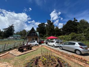 a group of cars parked in front of a house at CHILLY CHALET Cabana in Nuwara Eliya