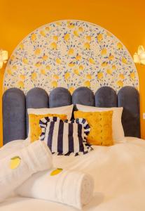 a bed with a blue and yellow head board at Ciao Bella Wellness Suite - Luxury Jacuzzi, Massage Table & AC in Central Nice in Nice