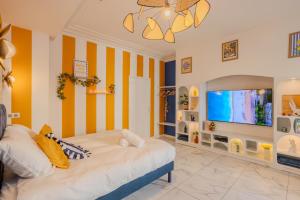 a bedroom with a bed and a flat screen tv at Ciao Bella Wellness Suite - Luxury Jacuzzi, Massage Table & AC in Central Nice in Nice