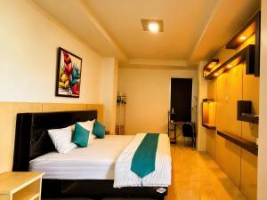 a bedroom with a bed in a room at De BOUGENVILLE Tulap Beach Front in Watulanei