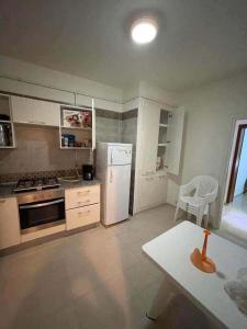 a kitchen with a white refrigerator and a table at HERGLA Sousse Zone Touristique in Harqalah +14 photos