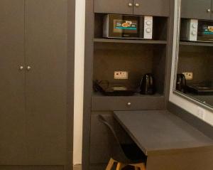 a kitchen with a counter and a microwave at Caritas Inn Igbobi in Lagos