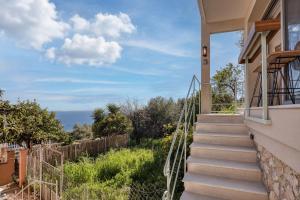 a set of stairs leading up to a house with a view at TINY HOUSE STUDIO AT COURTYARD COTTAGE CORFu in Lákones