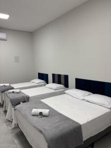 a row of beds in a room at Quartos Sinop in Sinop