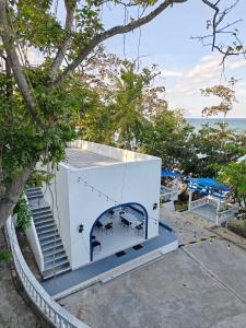 a house with a mural on the side of it at De BOUGENVILLE Tulap Beach Front in Watulanei +14 photos