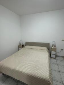 a bedroom with a bed and two night stands at Il Vicoletto in Biccari +3 photos