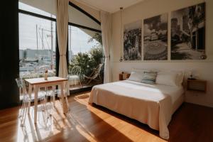 a bedroom with a bed and a table and a window at Locanda da Toto in Genoa
