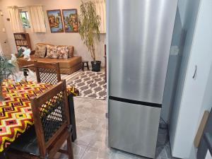 a kitchen with a refrigerator in a living room at Bavarian Getaway in Kloof