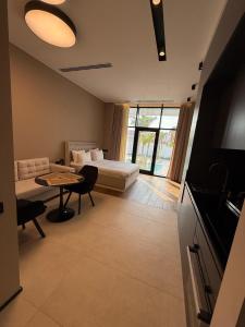 a living room with a bed and a table and a couch at Sea Breeze Lighthouse in Nardaran
