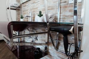 a bathroom with a sink and a black chair at Escape Anzio- intero appartamento in Anzio +15 photos