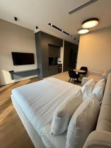 a large white bed in a room with a table at Sea Breeze Lighthouse in Nardaran +6 photos