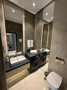 a bathroom with a sink and a washing machine at Sea Breeze Lighthouse in Nardaran