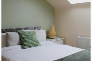 a bedroom with a white bed and a vase on a table at 1 Bed Flat - Sleeps 2 - Parking - Wifi in Newport