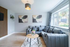 a living room with a couch and a table at Spacious 3 Bedroom House in Ashton-under-Lyne by Eason Stays with Free Parking and Courtyard View in Stalybridge