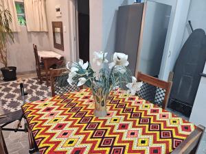 a table with a vase of flowers on it at Bavarian Getaway in Kloof