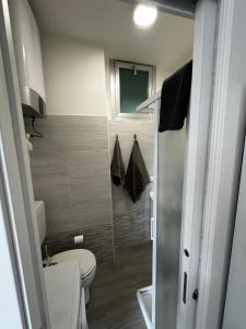 a small bathroom with a toilet and a shower at Bibione Beach Home in Bibione +13 photos