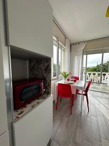 a living room with a table and a tv in a room at Bibione Beach Home in Bibione