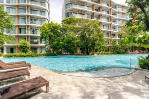 a swimming pool in front of some apartment buildings at Phyll Condominium Luxury 301 2bedroom, Phuket in Ban Rangeng