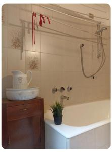 a bathroom with a tub and a sink and a shower at Casa Lu' in Bosisio Parini +4 photos