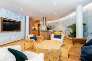a living room with blue and white walls at Phyll Condominium Luxury 301 2bedroom, Phuket in Ban Rangeng