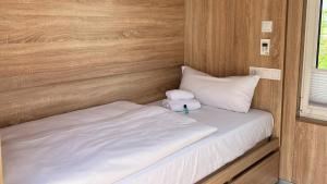 a small bed with a teddy bear sitting on top of it at Roatel Willich A44 my-roatel-com in Willich