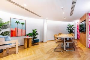 a dining room with a table and chairs and palm trees at Phyll Condominium Luxury 301 2bedroom, Phuket in Ban Rangeng