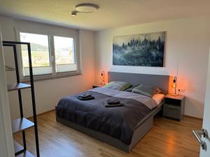 a bedroom with a bed and a painting on the wall at Lakeview Residence in Schluchsee