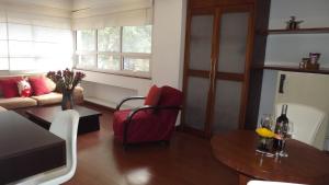 a living room with a couch and a table at Hotel Retiro 84 in Bogotá