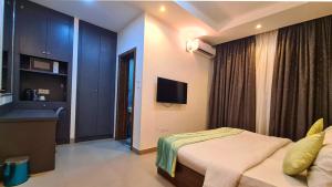a bedroom with a bed and a television in it at Caritas Inn Igbobi in Lagos +14 photos