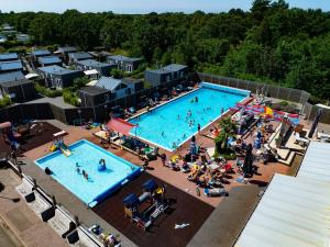 an overhead view of a pool with people in it at Lodge Jacques Cousteau XXL in Renesse