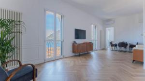 a living room with white walls and a wooden floor at LEtoile du Lac in Blevio +39 photos