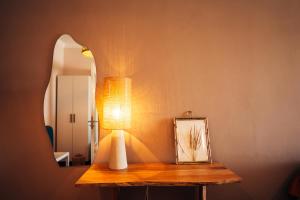 a lamp on a table in front of a mirror at Aether View Premium Views in Central Mytilene in Mytilene +28 photos