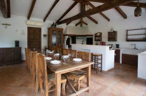 a dining room with a wooden table and chairs at Casa Chimo in Moraira