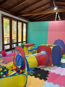 a childrens play room with a colorful play equipment at Canas Gold Praia Hotel in Florianópolis