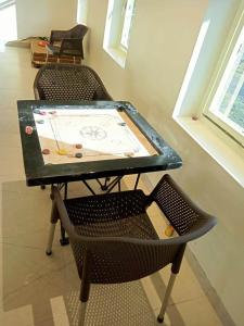 a table and a chair with a glass top at The Infinity Pench Resort in Khawāsa +19 photos